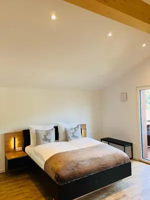 a bedroom with a large bed and a window at Apartments P19 nelle Dolomiti in Ortisei