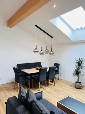 a living room with a table and chairs at Apartments P19 nelle Dolomiti in Ortisei