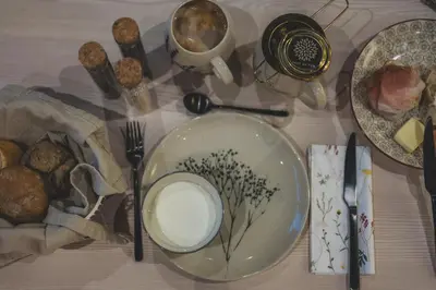 a table topped with a plate with a bowl of milk at O'Mama family time - am Eggerhof in Mühlbach