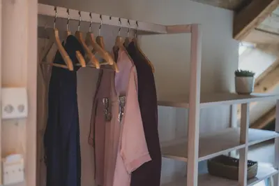 a closet with a rack of clothes at O'Mama family time - am Eggerhof in Mühlbach