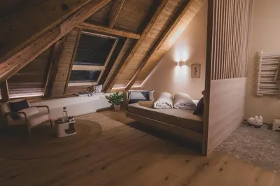 a bedroom with a bed in a room with wooden ceilings at O'Mama family time - am Eggerhof in Mühlbach