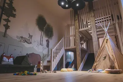 a childs room with a play area with a play tent at O'Mama family time - am Eggerhof in Mühlbach
