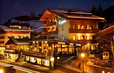 a hotel in the mountains at night at Hotel Euròpa Dolomites in Selva di Val Gardena