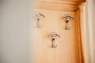 a wooden door with two handles on it at Hotel Euròpa Dolomites in Selva di Val Gardena