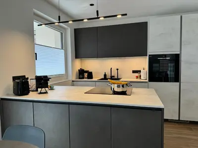 a kitchen with a large counter top with a sink at Lilena Apartment in Merano