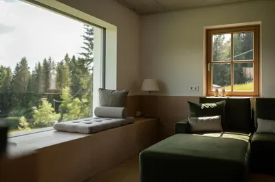a living room with a couch and a window at Haus Engadein in Auna di Sopra