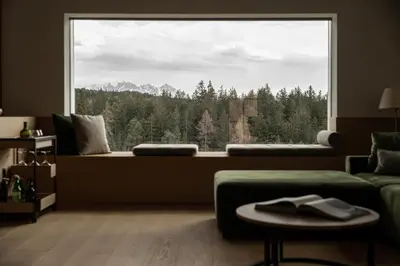 a living room with a large window with a mountain view at Haus Engadein in Auna di Sopra