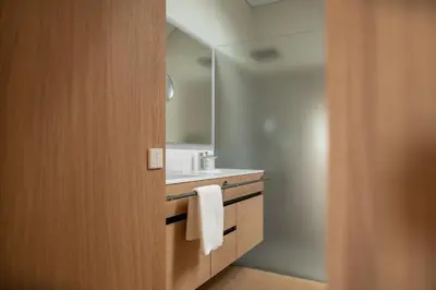 a bathroom with a sink and a mirror at Haus Engadein in Auna di Sopra