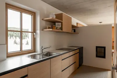 a kitchen with a sink and a window at Haus Engadein in Auna di Sopra