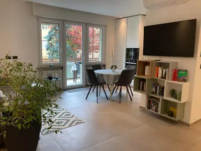 a living room with a table and chairs and a tv at Apartment Larissa in Merano