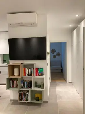 a living room with a flat screen tv on a wall at Apartment Larissa in Merano