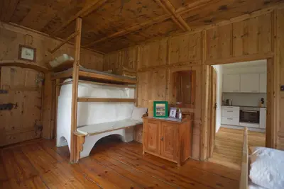 a bedroom with a bunk bed in a wooden cabin at Hofrichter in San Lorenzo di Sebato