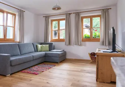 a living room with a couch and a television at Hofrichter in San Lorenzo di Sebato