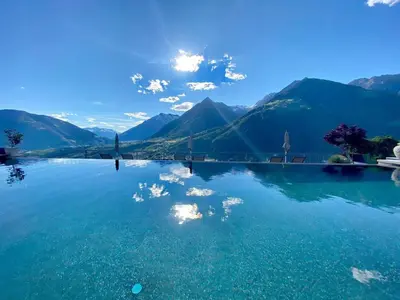 a large body of water with mountains in the background at Lifestyle Hotel Alpin in Schenna