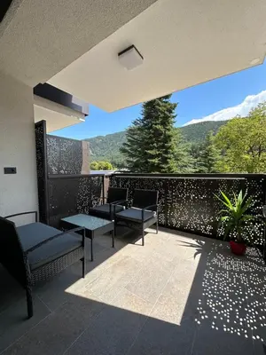 a balcony with chairs and a view of the mountains at SiJa in Mühlbach