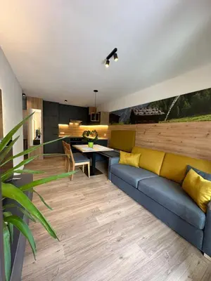 a living room with a couch and a table at SiJa in Mühlbach