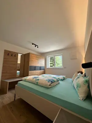 a bedroom with a bed and a window in it at SiJa in Mühlbach