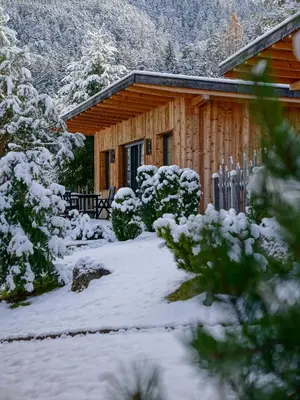 a small house behind a white picket fence at Camping Seiser Alm in Fiè