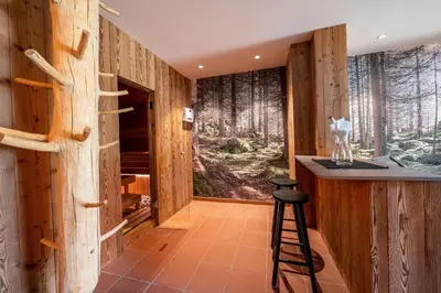a leather couch sitting in a room with windows at Camping Seiser Alm in Fiè