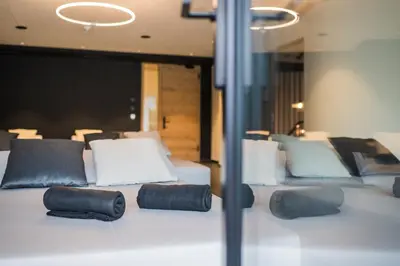a room with two beds with black and white pillows at Montanaris Alpine - Active - Relax in Villabassa