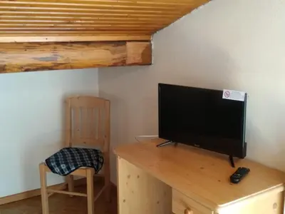 a television sitting on a wooden desk in a room at Hotel Garnì Miramonti in Falcade