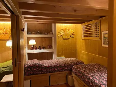 a small room with two beds in a house at Casa Peragallo Cortina in Cortina dʼAmpezzo