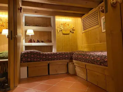 a room with a bench in the corner of a room at Casa Peragallo Cortina in Cortina dʼAmpezzo