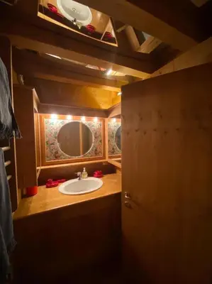 a bathroom with a sink and a mirror at Casa Peragallo Cortina in Cortina dʼAmpezzo