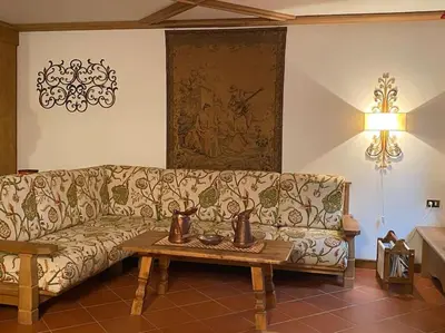 a living room with a couch and a coffee table at Casa Peragallo Cortina in Cortina dʼAmpezzo