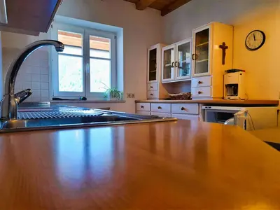 a kitchen with a wooden counter top and a sink at Villa Andre in Tires