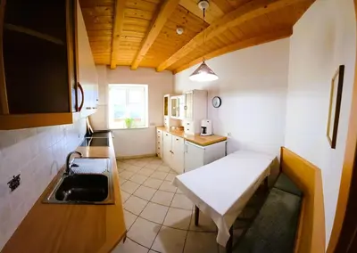 a small kitchen with a bench and a sink at Villa Andre in Tires