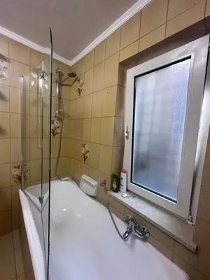 a bathroom with a shower and a sink and a window at Oma Nani in Campitello di Fassa