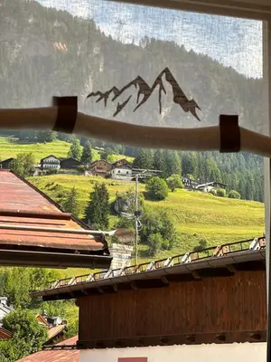 a view of a mountain from the window of a house at Oma Nani in Campitello di Fassa