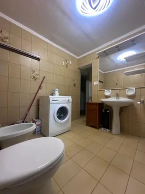 a bathroom with a washing machine and a sink at Oma Nani in Campitello di Fassa