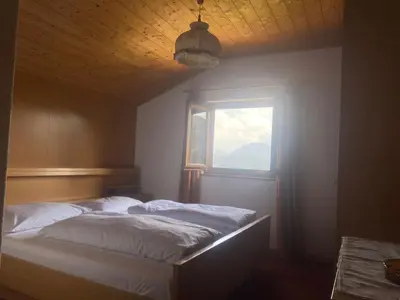 a bedroom with two beds and a window at Mitterhofer in Villandro