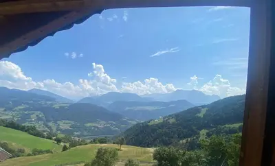 a view from a window of a valley with mountains at Mitterhofer in Villandro