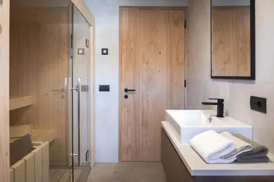 a bathroom with a sink and a shower at Sottla - your mountain home in Valdaora