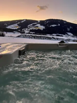a bath tub filled with water with snow at Sottla - your mountain home in Valdaora