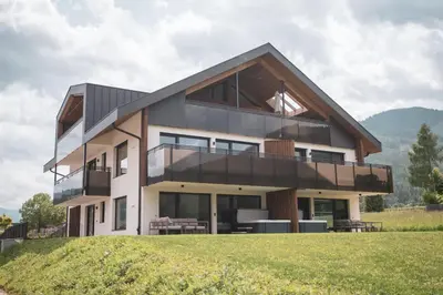 a house on top of a grassy hill at Sottla - your mountain home in Valdaora