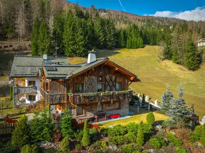 an aerial view of a log home with a mountain at Alpine Mountain Chalet in San Vigilio Di Marebbe