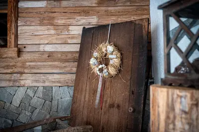 a bird nest hanging on a wooden wall at Alpine Mountain Chalet in San Vigilio Di Marebbe