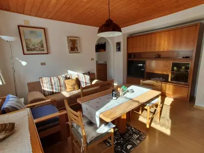 a living room with a table and a couch at Apartments Somavia in Ortisei