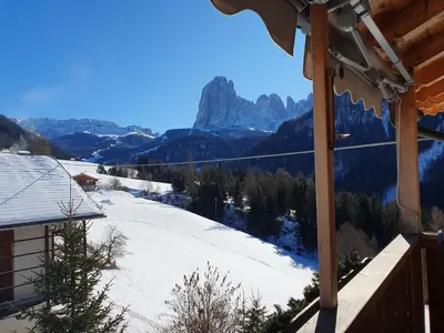 a view of a snow covered mountain from a house at Apartments Somavia in Ortisei