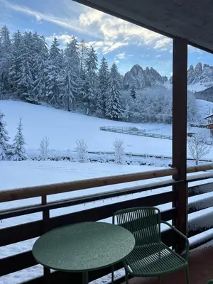 a building covered in snow with a fence at MiraOdle Apartments in Villnoss