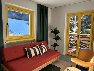 a green kitchen with a sink and a table at MiraOdle Apartments in Villnoss