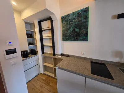 a kitchen with white cabinets and a counter top at Sweet Piccolino in Merano