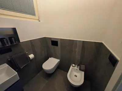 a bathroom with a toilet and a sink at Sweet Piccolino in Merano