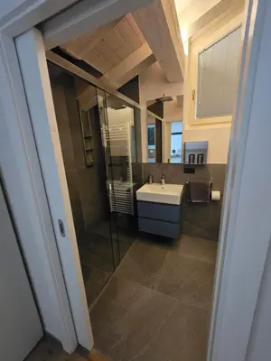a bathroom with a sink and a mirror at Sweet Piccolino in Merano