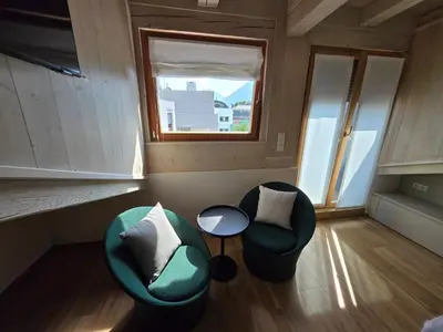 a room with two chairs and a table and a window at Sweet Piccolino in Merano