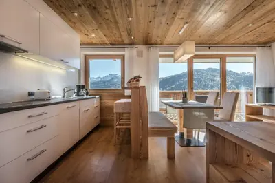 a bedroom with a bed in a room with windows at Appartements Chalet Bandiarac in San Cassiano